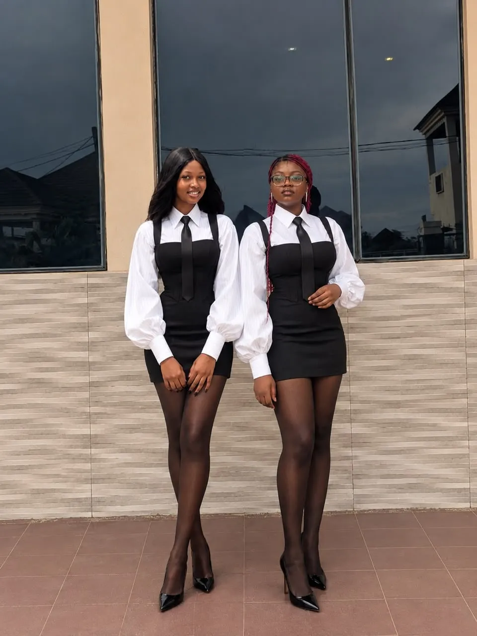 Two Anara ushers in the signature black and white uniform